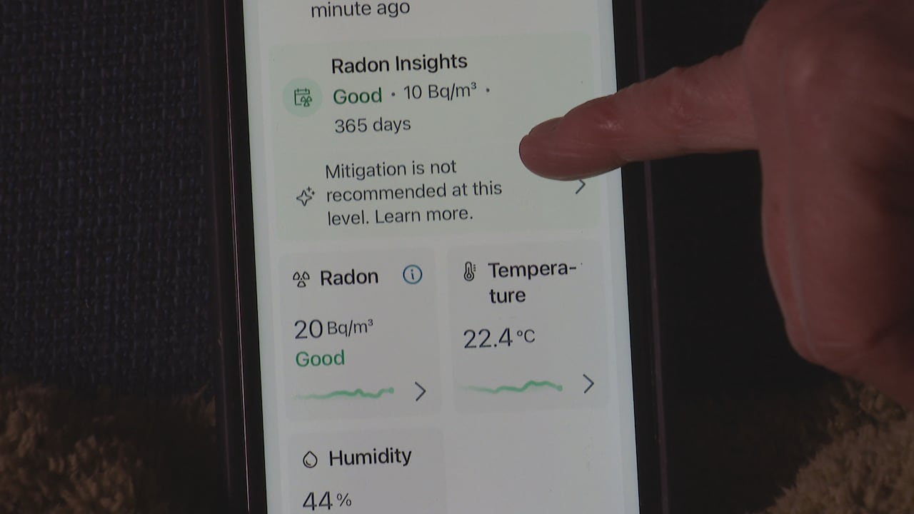 A smartphone shows an app that records real-time radon levels.
