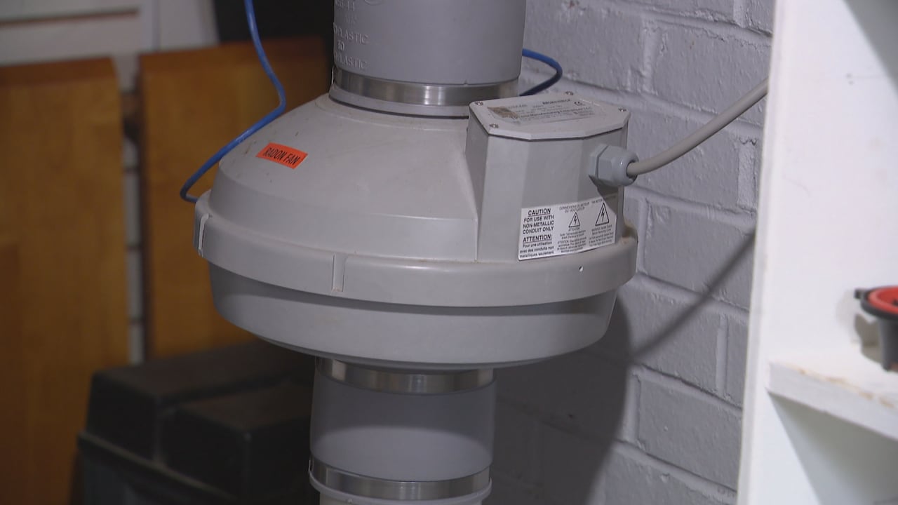 A pipe leads to an internal fan that draws air up from under the building.