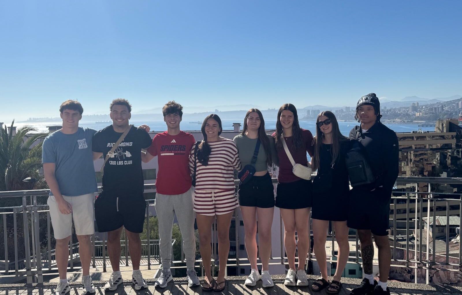 Spider student-athletes pose in front of a cathedral in Chile