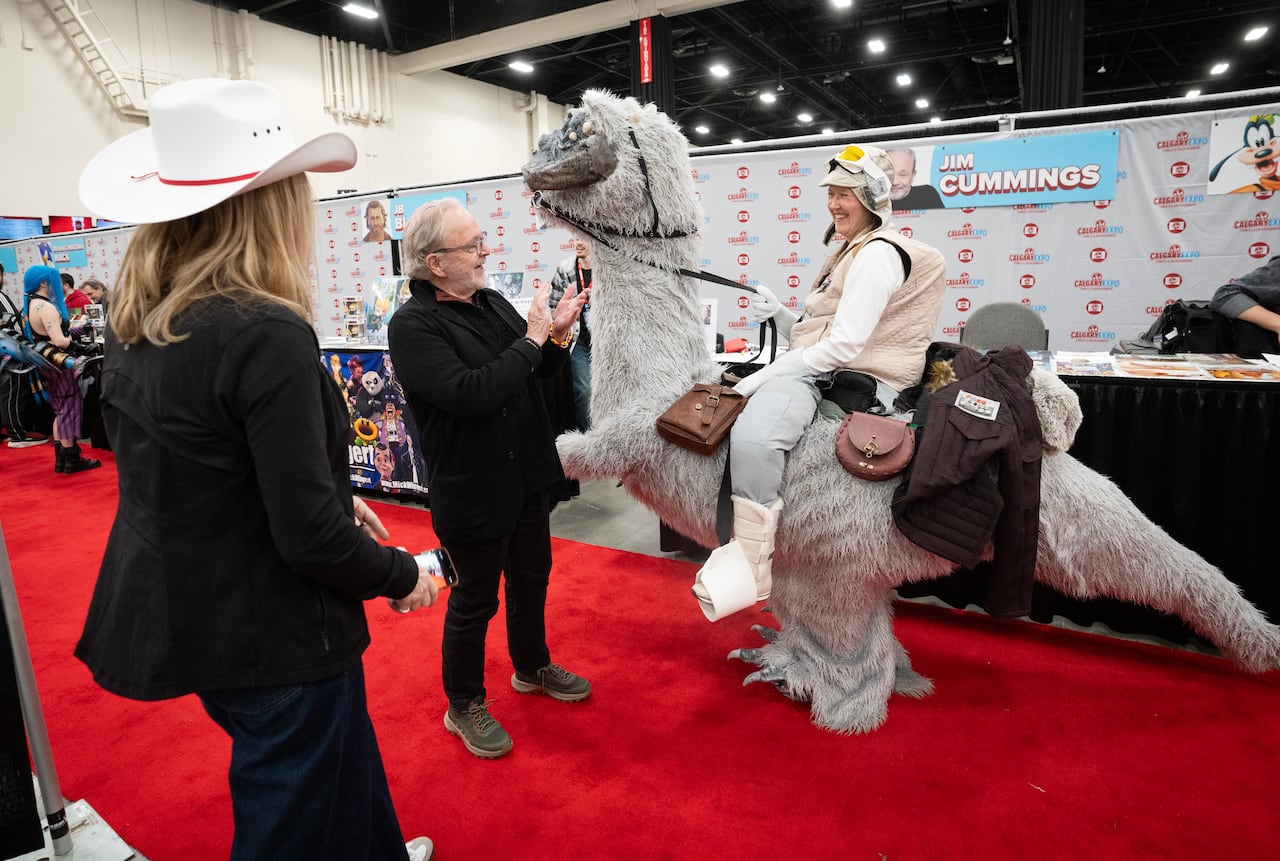 A person in a costume riding a large creature.