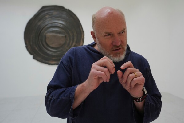 Artist Alma Allen gestures as he speaks with the Associated Press inside the United States pavilion 'Call Me the Breeze' at the Venice 2026 Biennale Art, in Venice, Italy, Tuesday, May 5, 2026. (AP Photo/Luca Bruno)