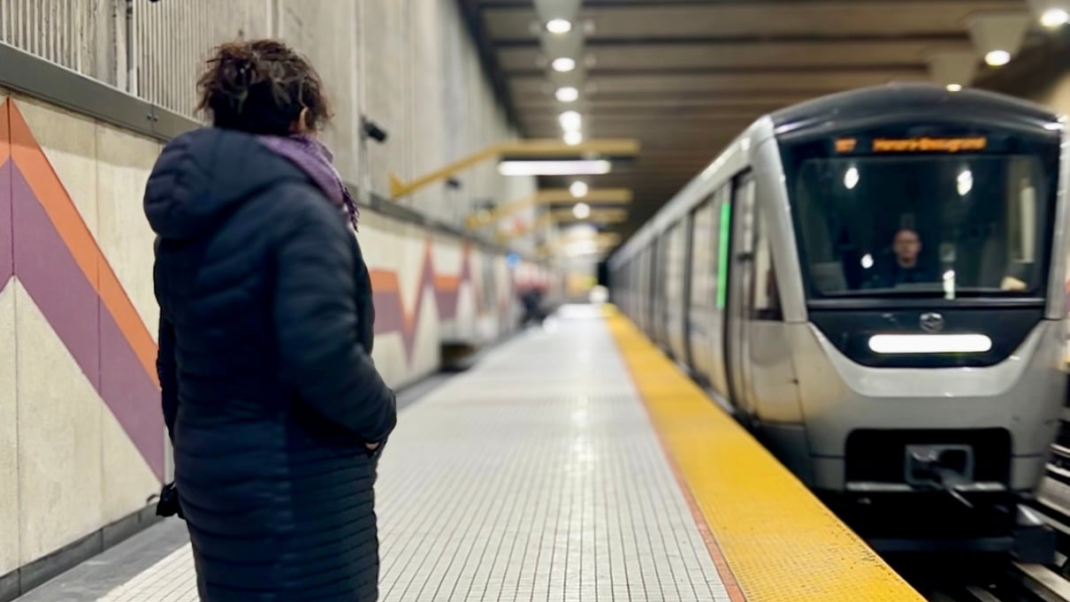 woman standing on metro platform