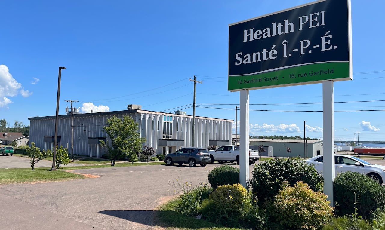 A small building with a large black and green sign saying Health P.E.I. 