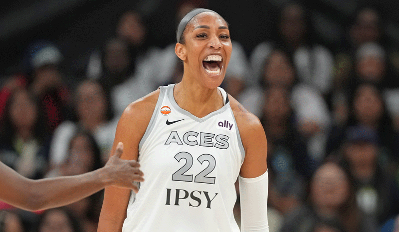 A’ja Wilson (22) reacts after scoring while drawing a foul during the first half against the Dallas Wings.