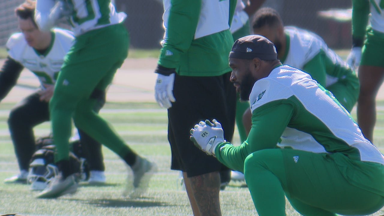 Football player Jameer Thurman squatting at training camp.