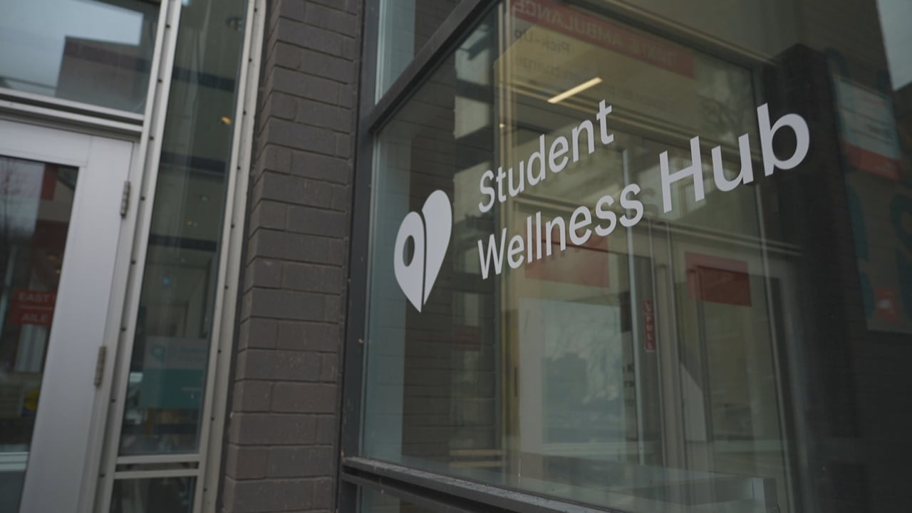 A pictire of a sign in a window for McGill's Student Wellness Hub