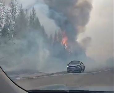 An image of the fire near Whitecourt captured by evacuee Jessica Adams as she drove to safety Monday evening.