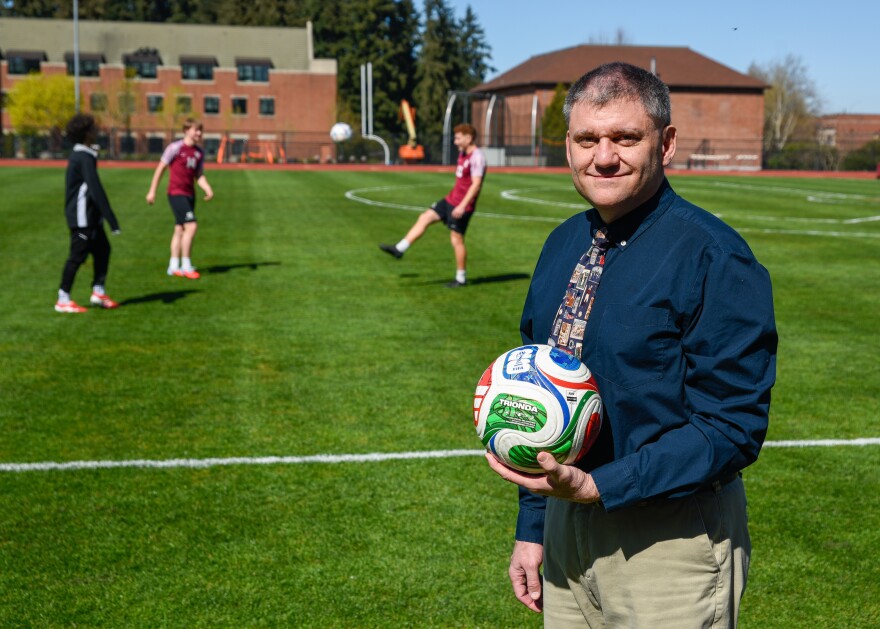 Sports physicists John Goff poses with Trionda, the official FIFA World Cup soccer ball, at the University of Puget Sound's soccer field. Goff worked with other physicists at the University of Tsukuba in Japan to test the ball's aerodynamics, ahead of this year's tournament.
