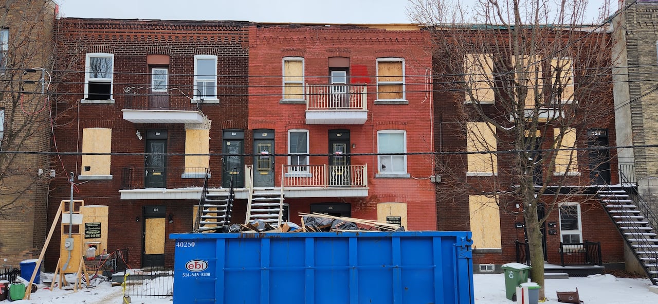Photo of three boarded up buildings after a fire.