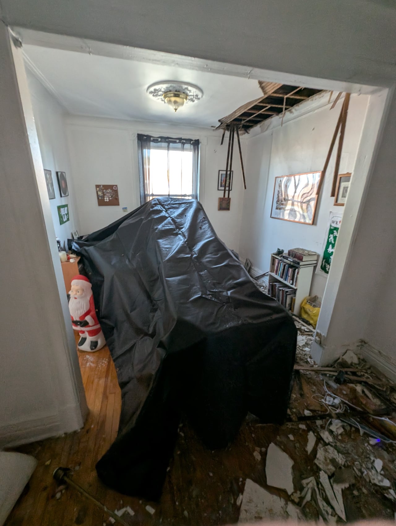 Picture of opened ceiling, debris in apartment after a fire next door.