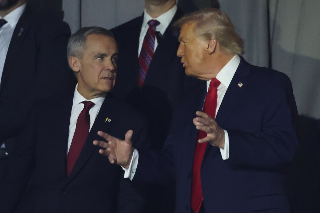 President Donald Trump talks to Canadian Prime Minister Mark Carney during the draw for the 2026 soccer World Cup at the Kennedy Center in Washington, Friday, Dec. 5, 2025.