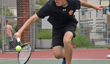 Edwardsville’s John Almos reaches for a backhand during the third-place doubles match of the Class 2A Edwardsville Sectional on May 24 inside the EHS Tennis Complex. 