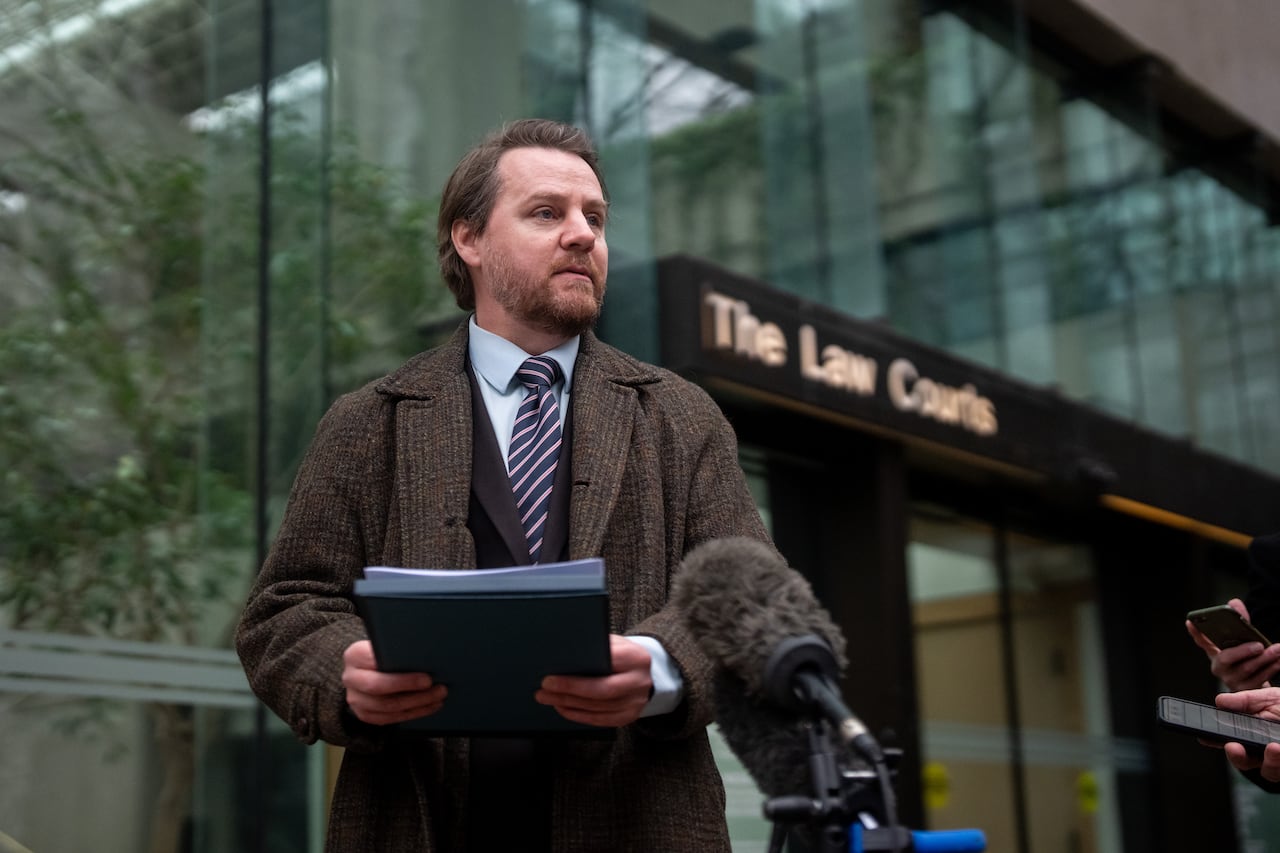 A man stands outside the Law Courts
