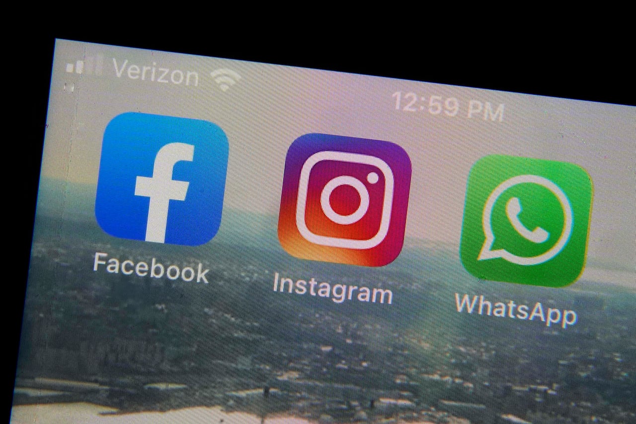 Mobile phone app logos for, from left, Facebook, Instagram and WhatsApp in are photographed in New York on Oct. 5, 2021.