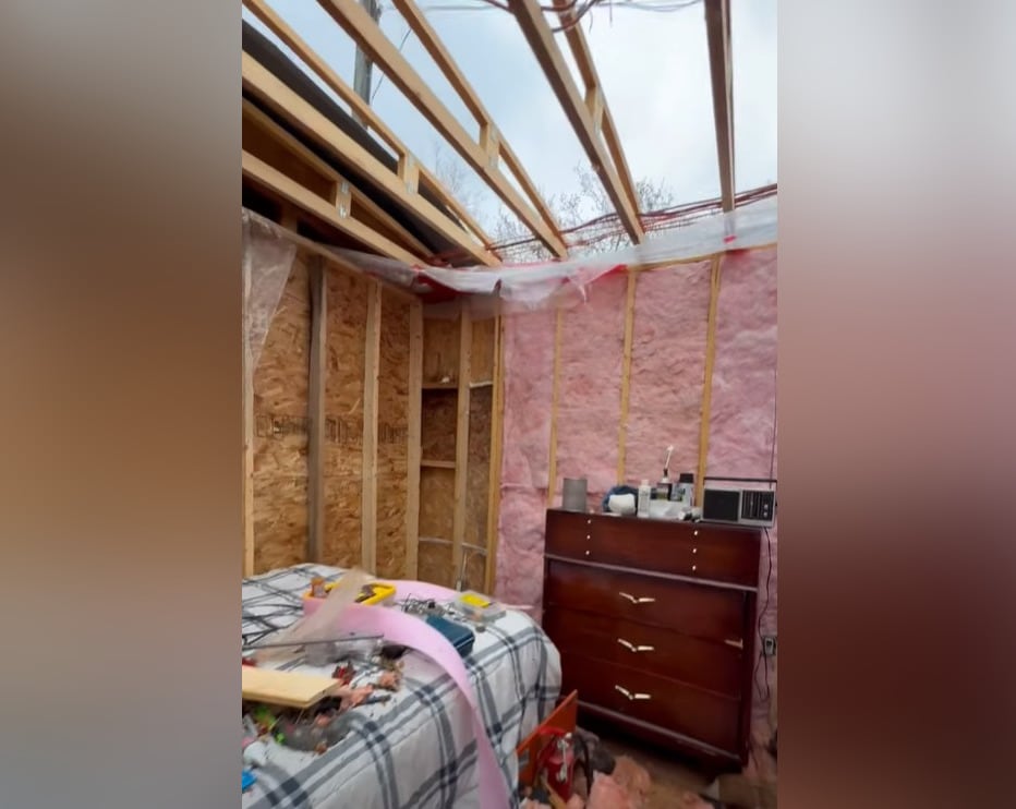 A mobile home from inside, showing the roof missing.