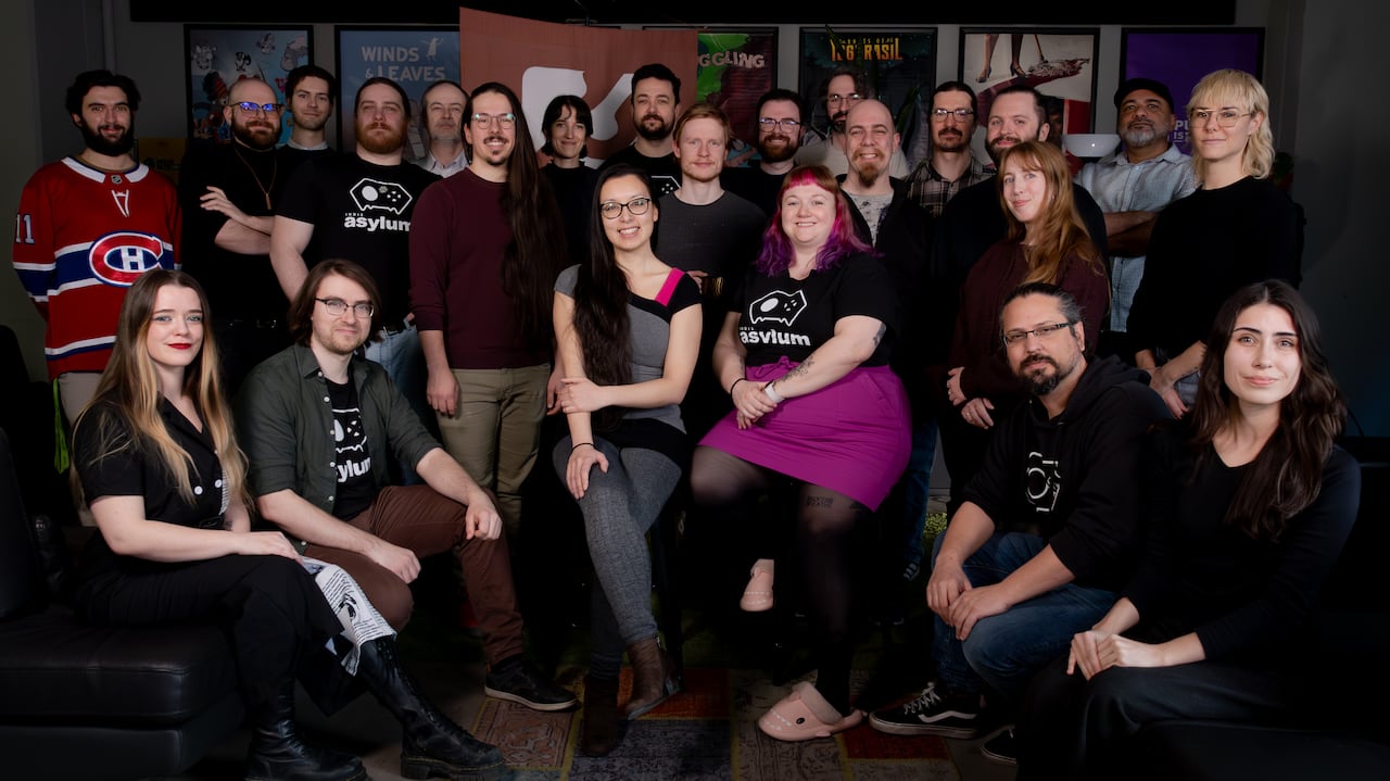 A group shot of more than a dozen smiling people