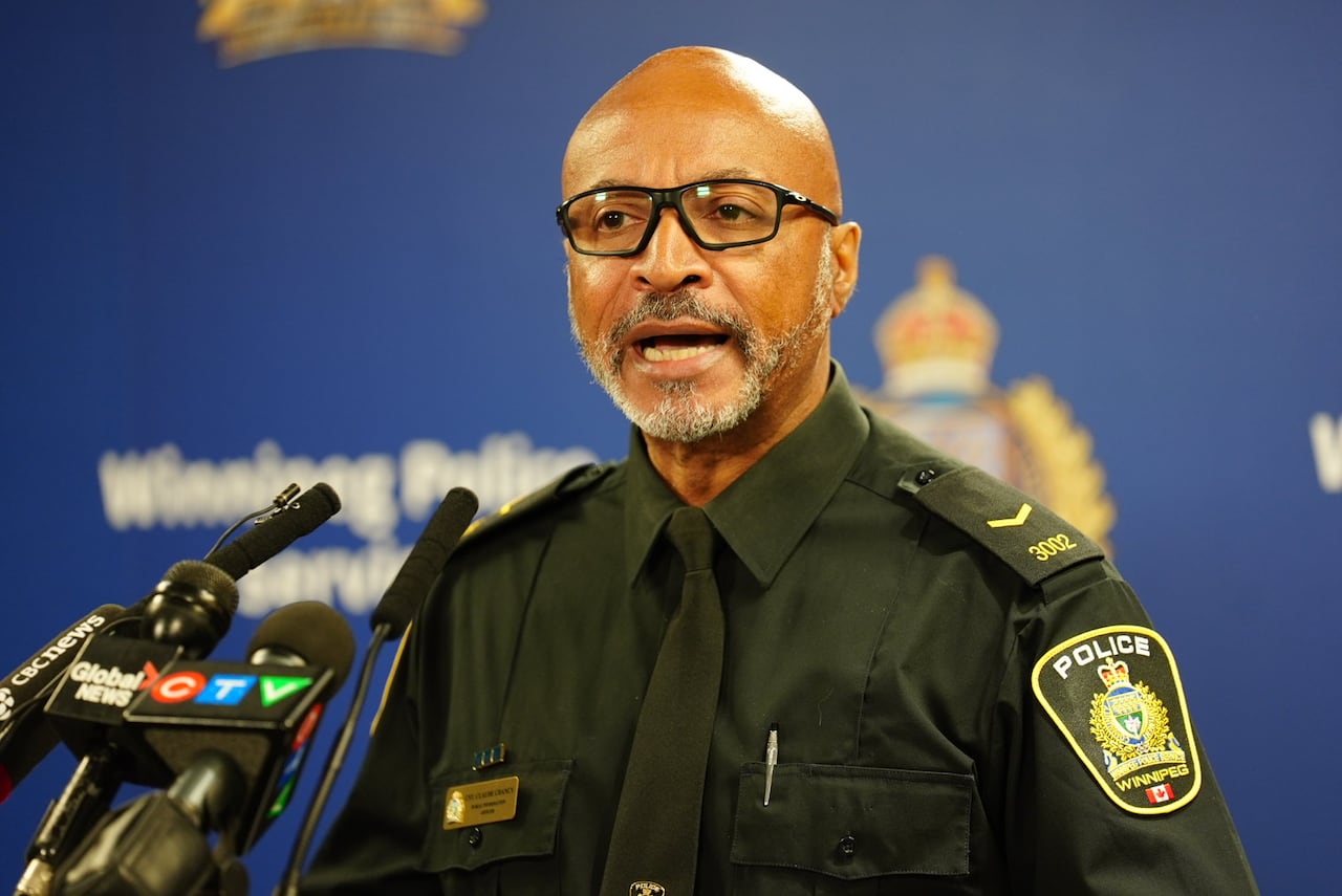 A police office speaks during a news conference.