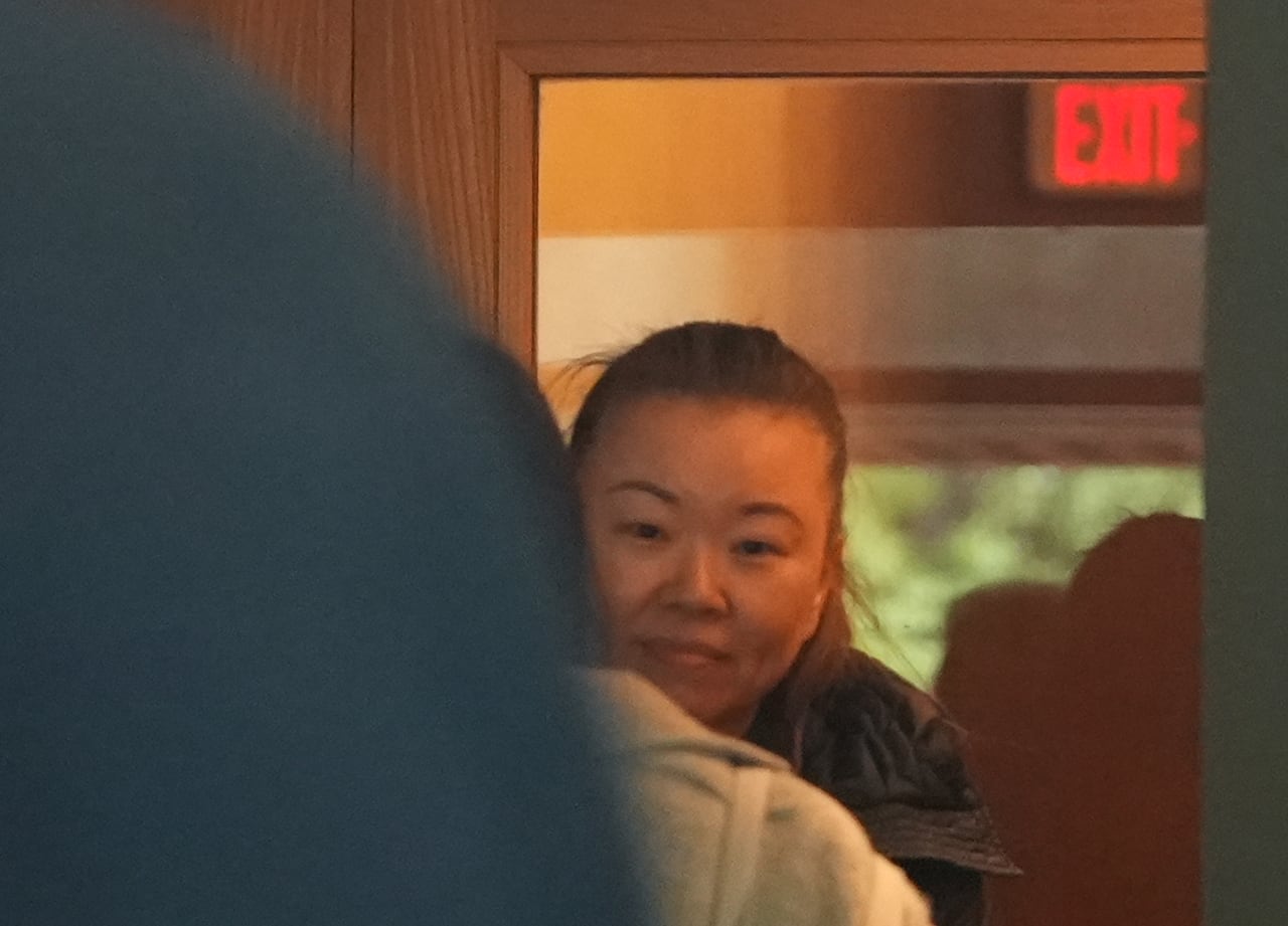 Helen Chan Sun peers outside shortly before entering the courtroom where she will be sent to jail for civil contempt. The 49-year-old began serving a 40-day sentence Friday.