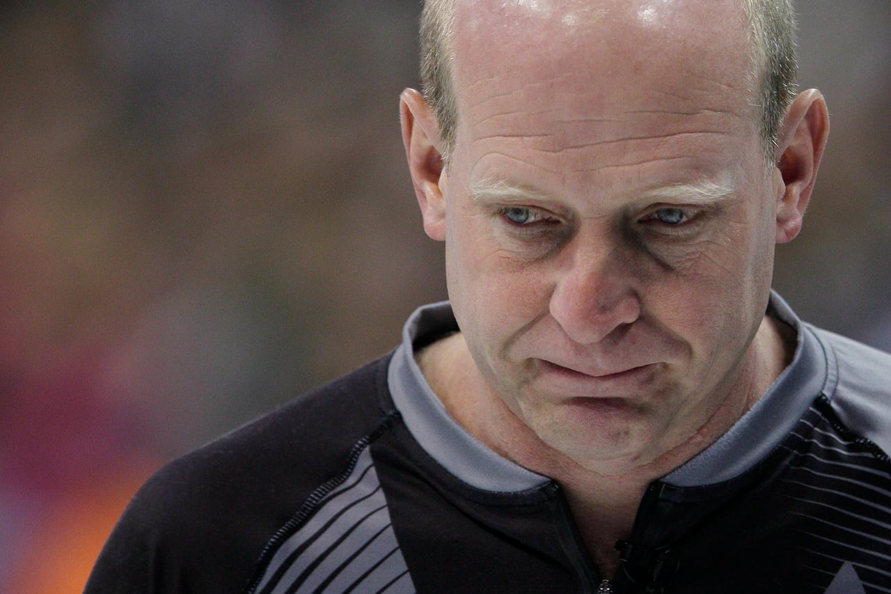 A curler has a disappointed look on their face.