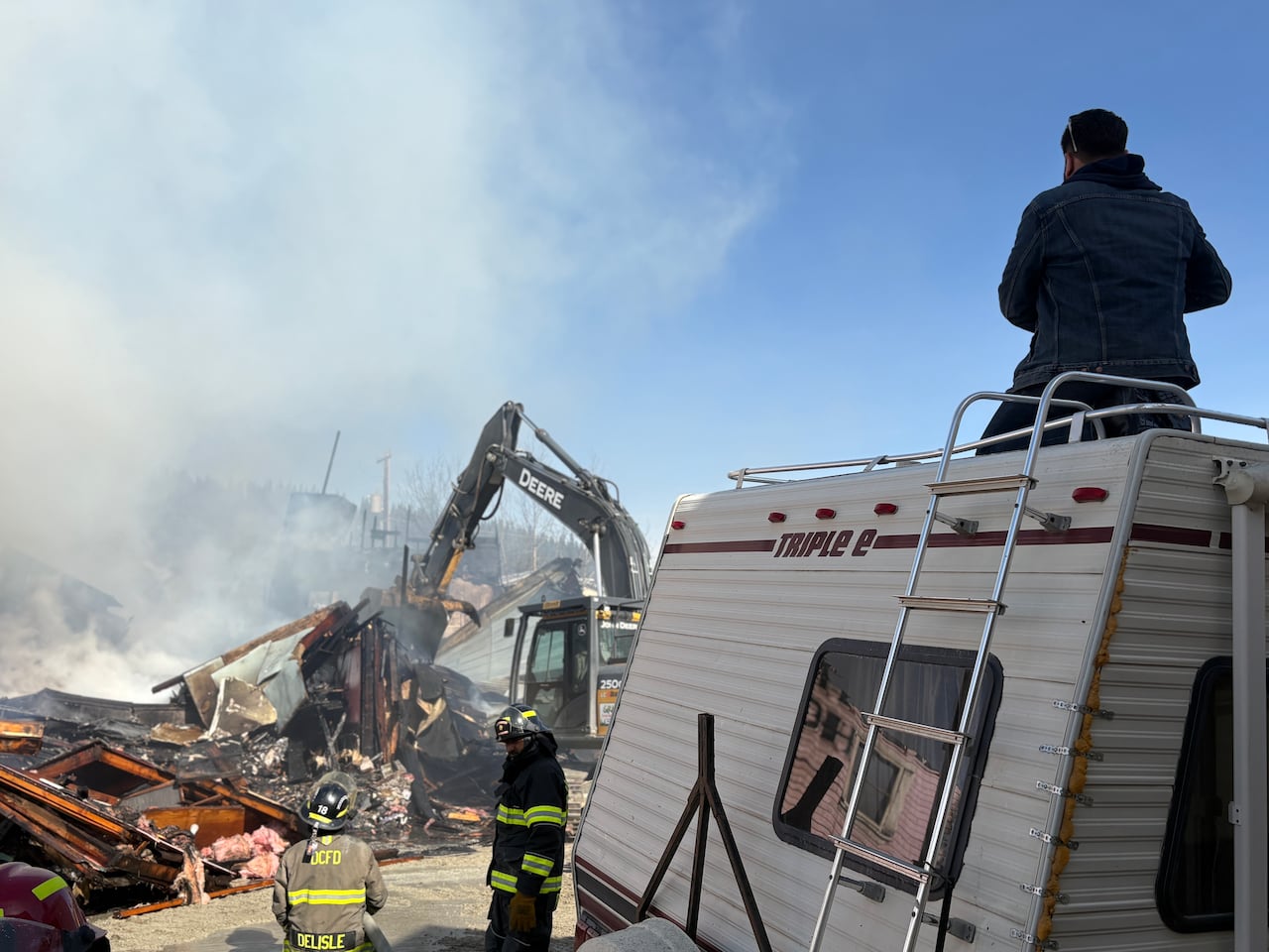 A man surveys the aftermath of the Westminster Hotel fire in Dawson City.