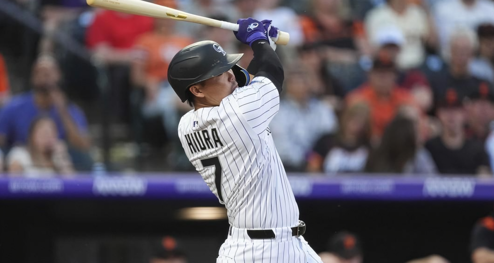 Keston Hiura of the Colorado Rockies hits an RBI single off San Francisco Giants starter Robbie Ray during the clubs