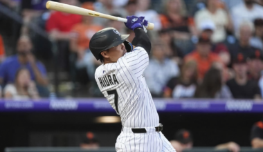 Keston Hiura of the Colorado Rockies hits an RBI single off San Francisco Giants starter Robbie Ray during the clubs