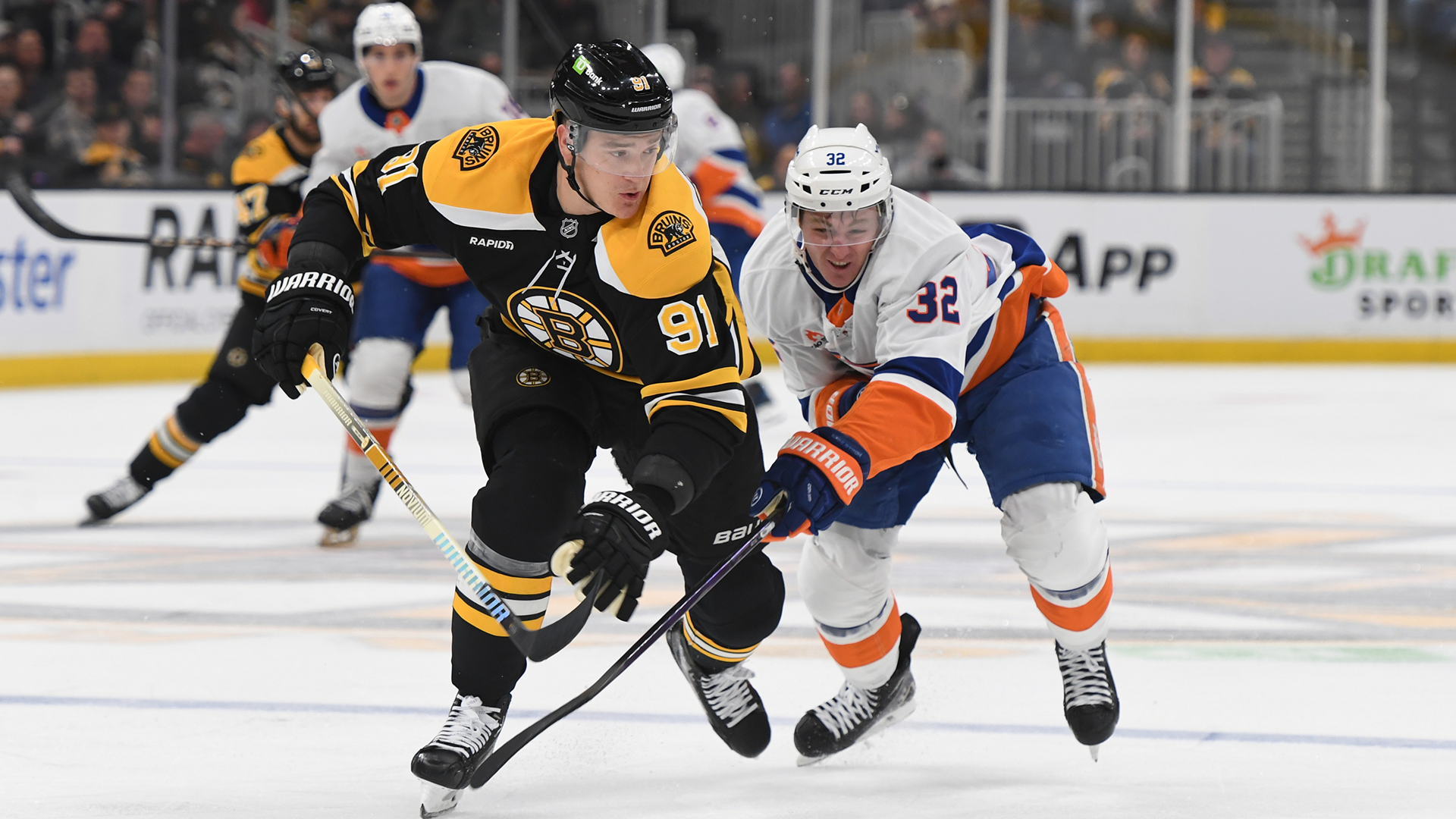 Nikita Zadorov of the Boston Bruins and Kyle MacLean of the New York Islanders during an NHL match.