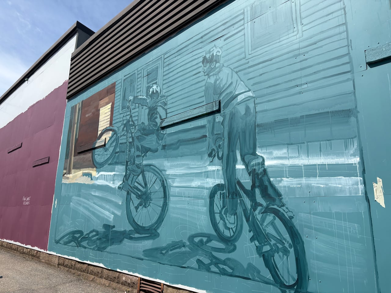 The rough sketch of a new mural in Sussex, New Brunswick. It depicts two boys on bikes popping wheelies.