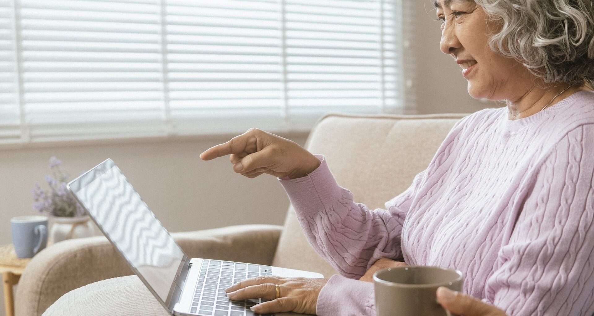 senior couple and documents with laptop for finance, budget planning or retirement annuity on sofa.