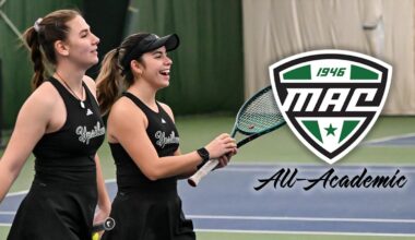 Iva Daneva and Regina Mendez Carreno pose together in front of an EMU banner with the CSC Academic All-District logo appearing to the left of the image