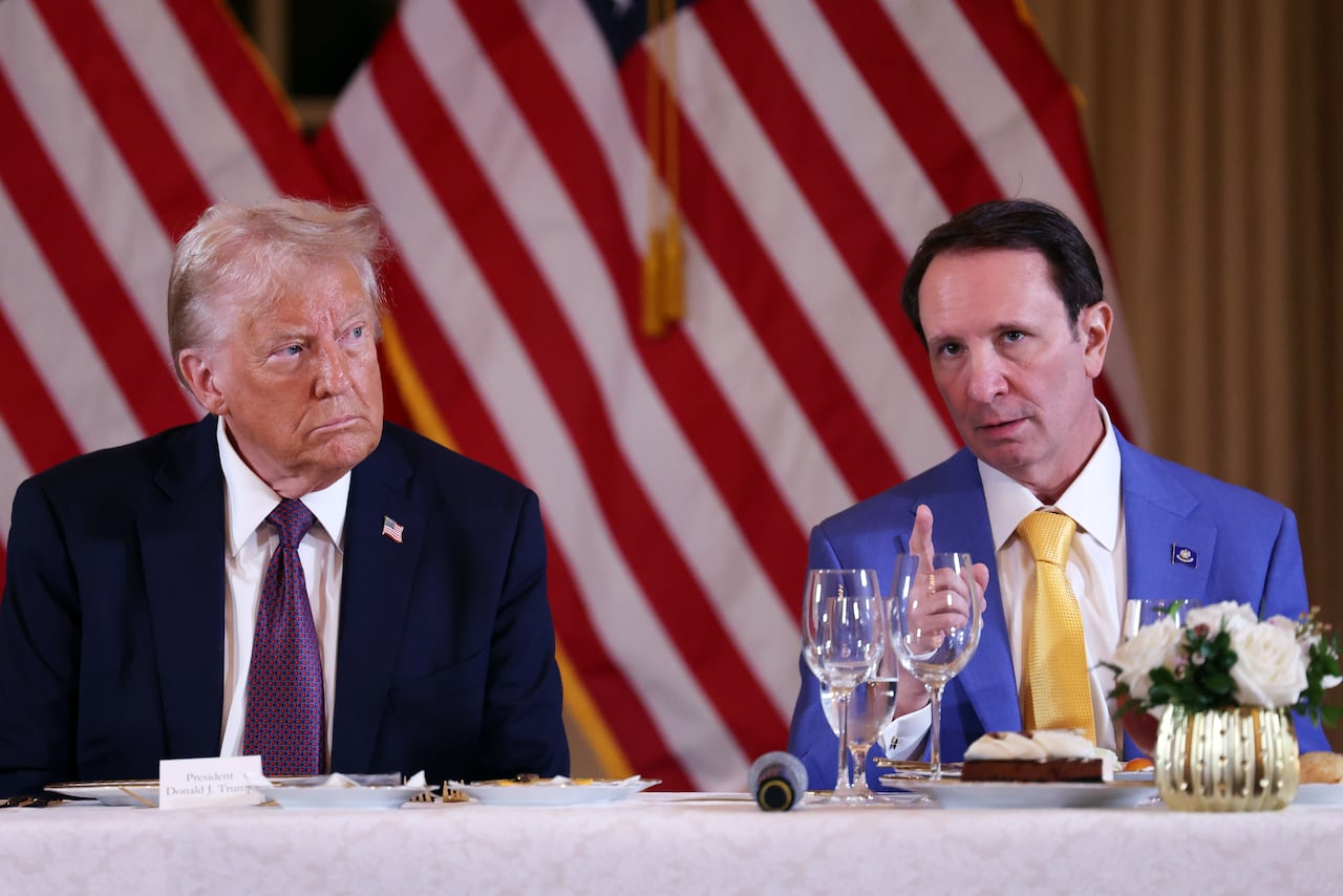 Two people sit at a dining table.