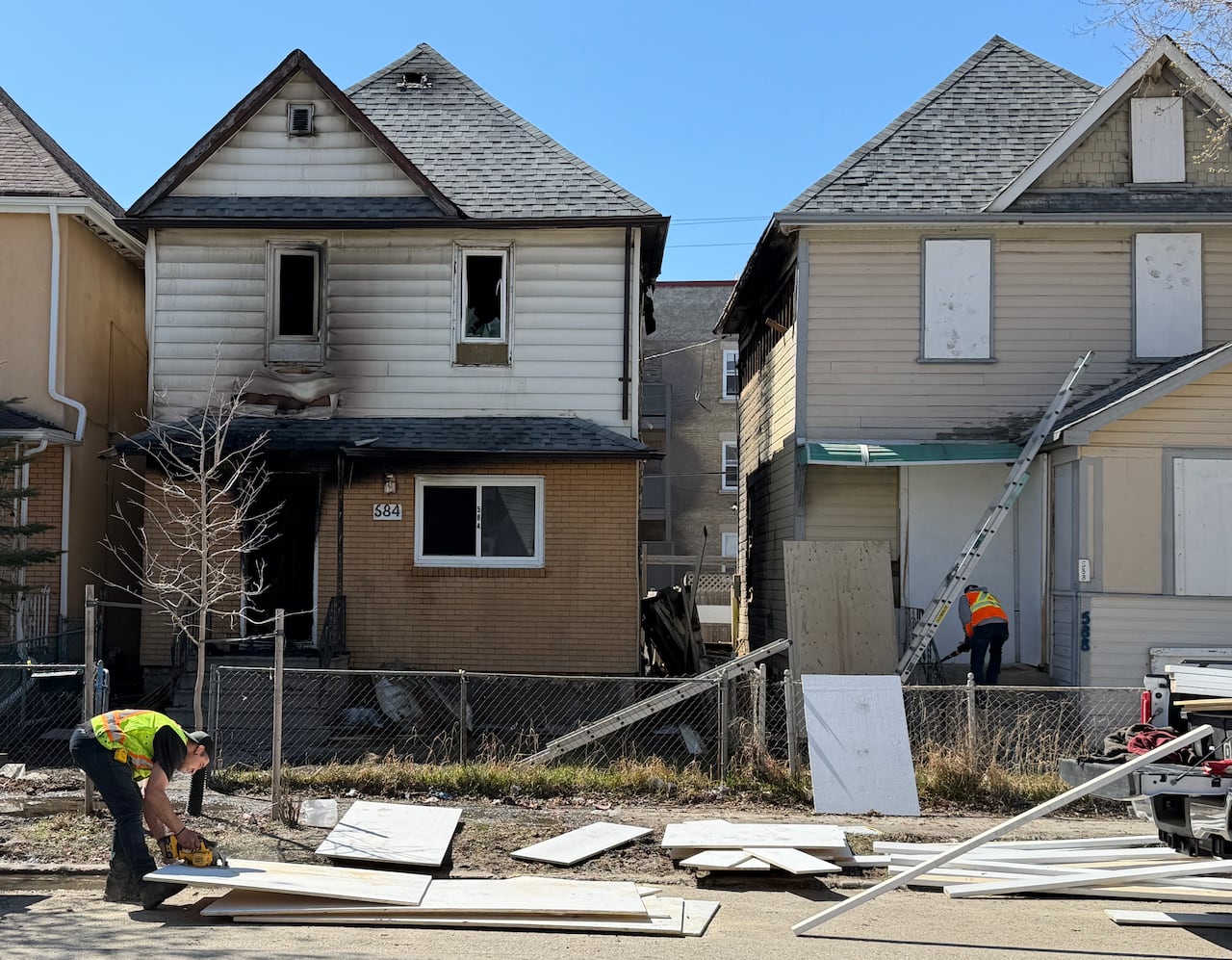 Houses get boarded up after a fire.
