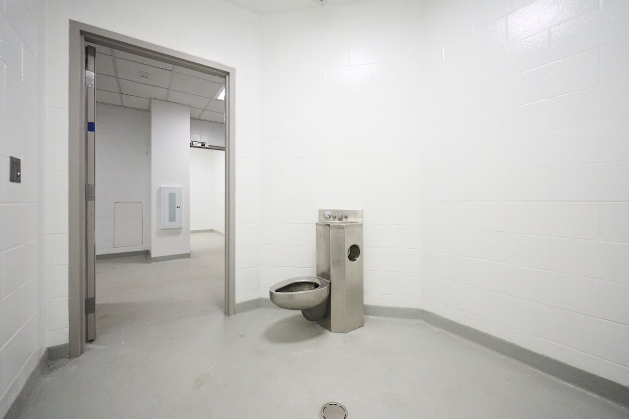A toilet and open door is shown.