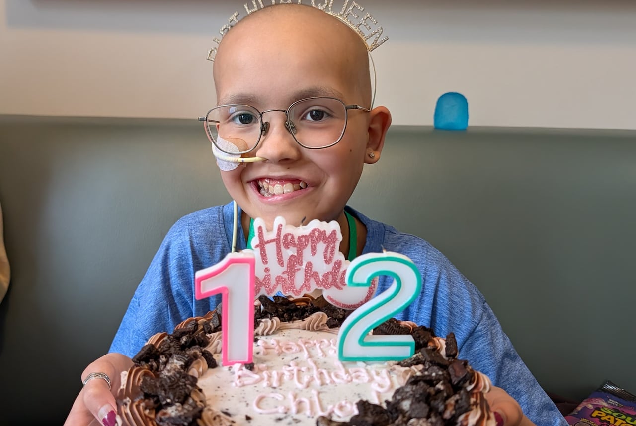 A little girl with a birthday cake