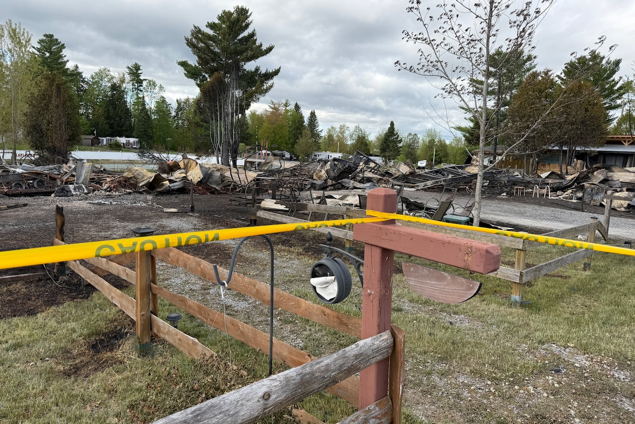Burnt aftermath of a fire at a mobile home community in spring.
