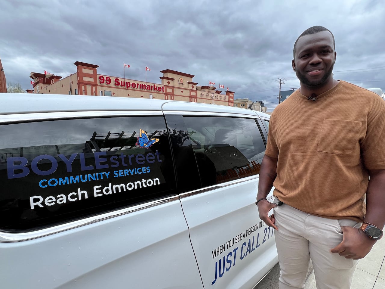 A man smiles while standing by an outreach van.