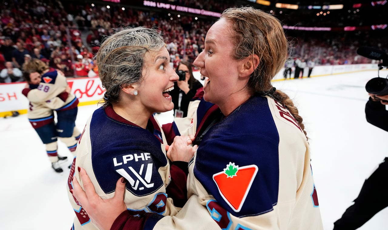 Women's hockey players celebrate.