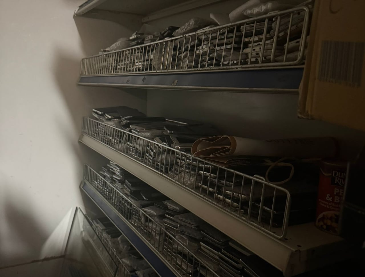 A police image shows shelved full of phones that officers expect were all stolen.