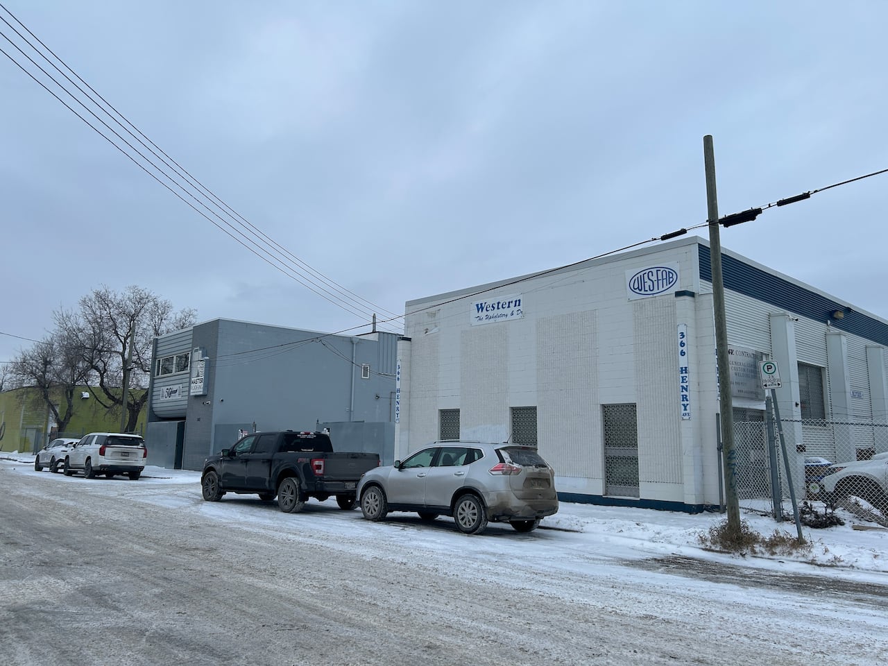 A white building on the side of a road.