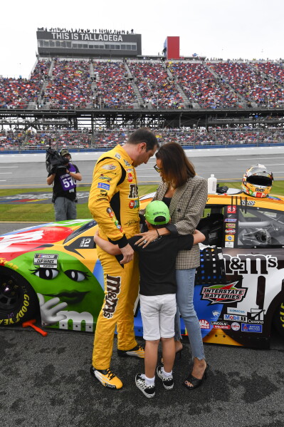 Kyle Busch, left, son Brexton, center, and wife Samantha put their arms around each other before a NASCAR Cup series auto race on Oct. 3, 2021, in Talladega, Ala. (AP Photo/John Amis, File)