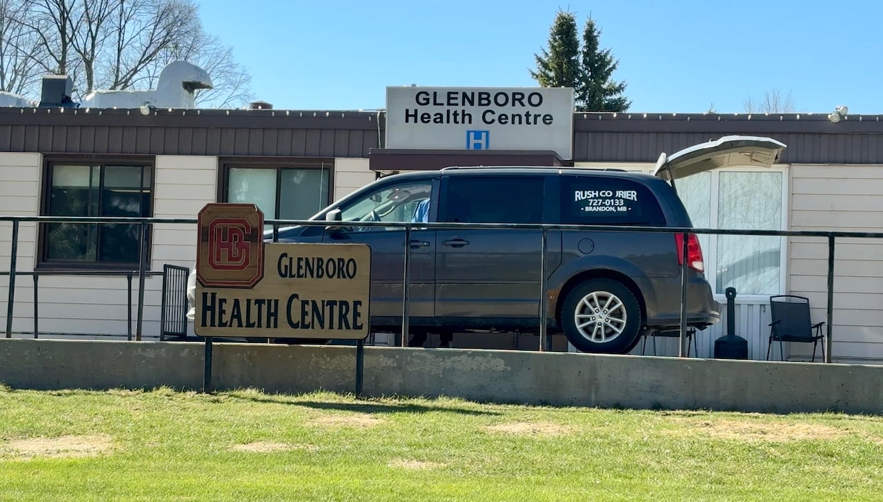 A van with the rear hatch open is parked on the top of a ramp in front of the Glenboro Health Centre