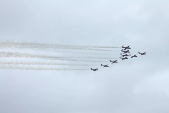 The Snowbirds of the Canadian Armed Forces fly over the grid in Canadair CT-114 Tutor jets.
