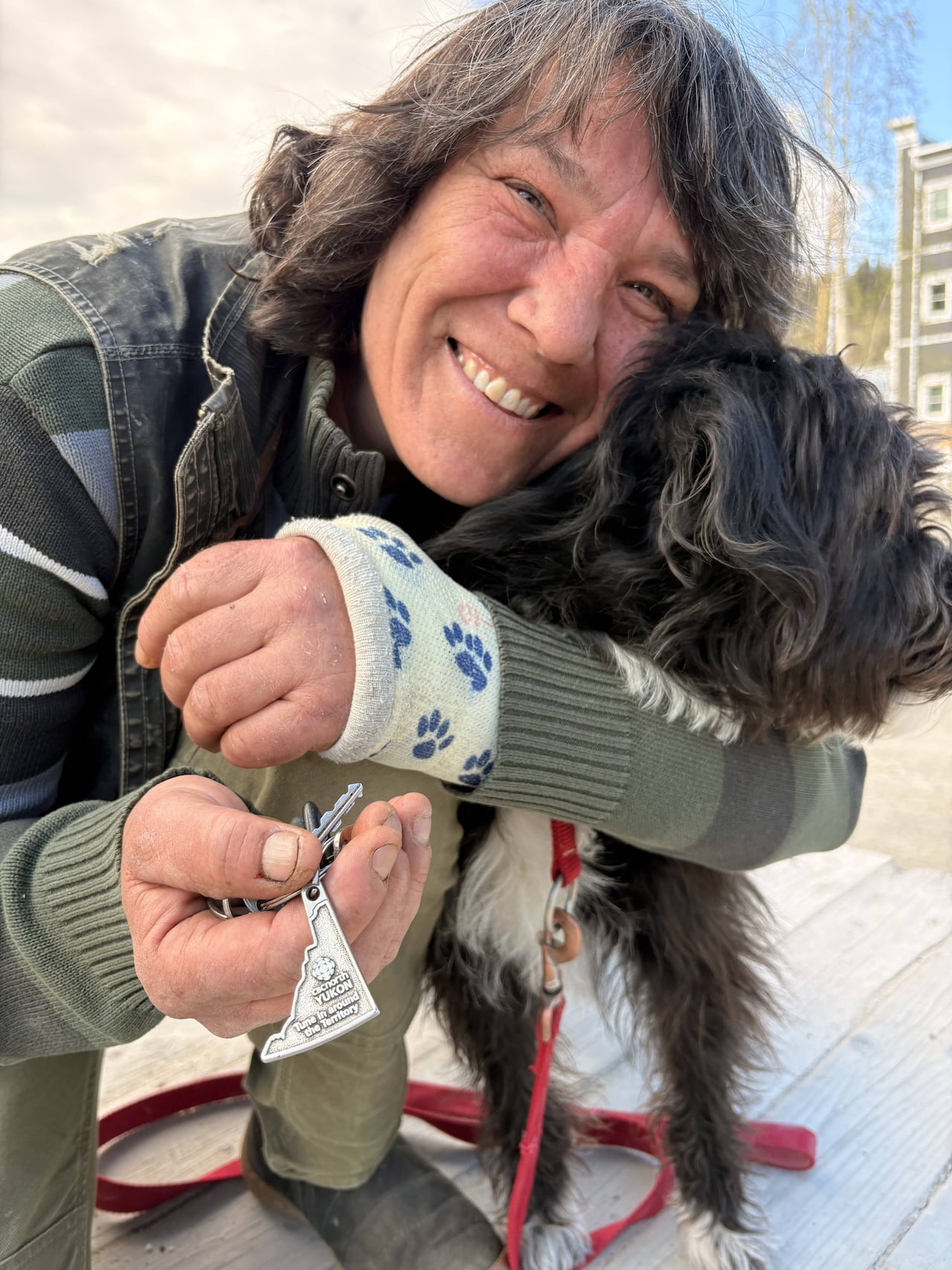 A CBC listener in Dawson City holds up her CBC keychain.