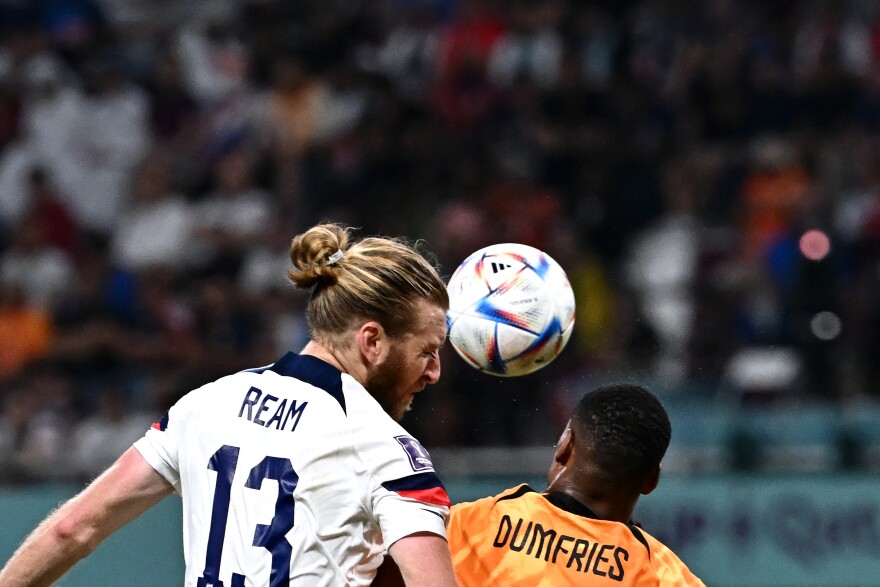 U.S. defender Tim Ream (L) and Netherlands' defender Denzel Dumfries fight for the ball during the Qatar 2022 World Cup round of 16 football match between the Netherlands and USA in Doha on December 3, 2022.