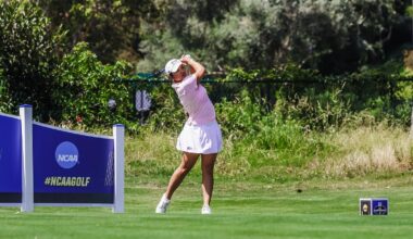 Kirstin Angosta connects with a golf ball on a tee shot.