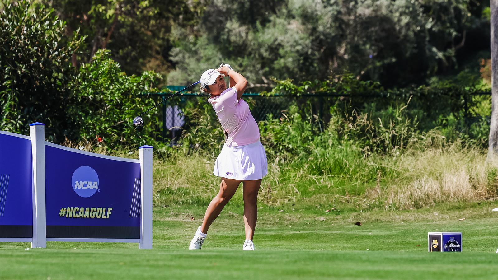 Kirstin Angosta connects with a golf ball on a tee shot.