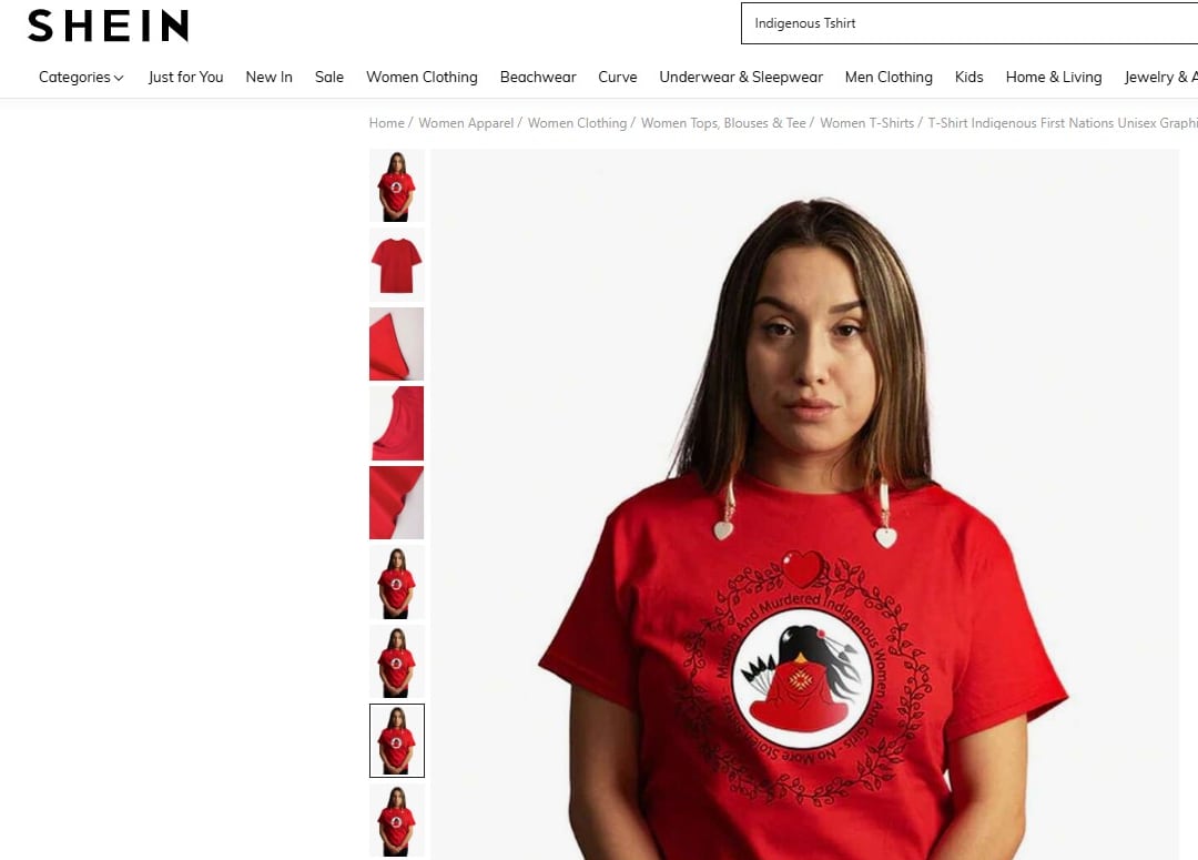 A girl stands wearing a red T-shirt