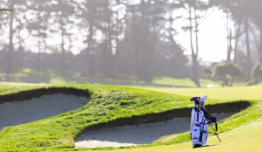 Emil Herstad and Finn Koelle walk with their bags alongside head coach Alan Murray during the final round of the NCAA Corvallis Regional