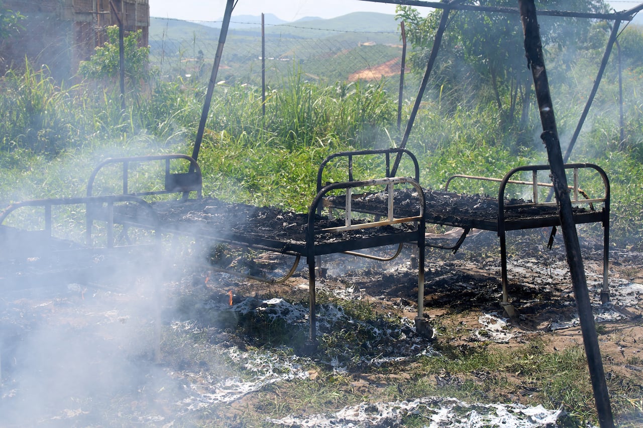 Charred hospital beds on the grass