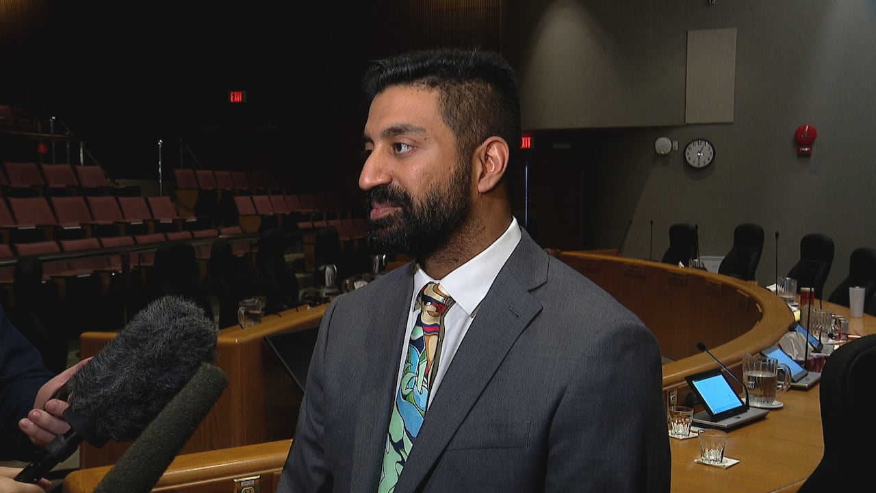 Saadiq Suumar speaking to reporters with mics